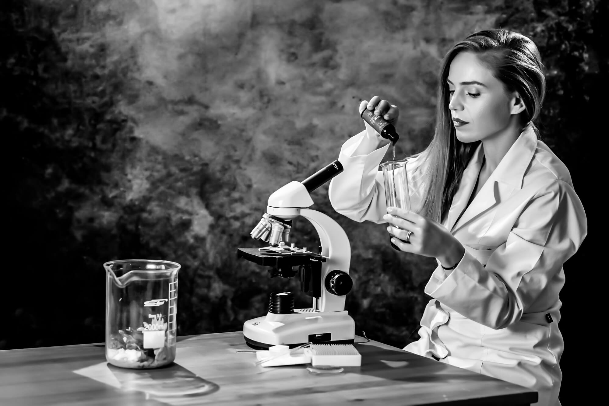 farmacist formulating a new recipe in front of a microscope